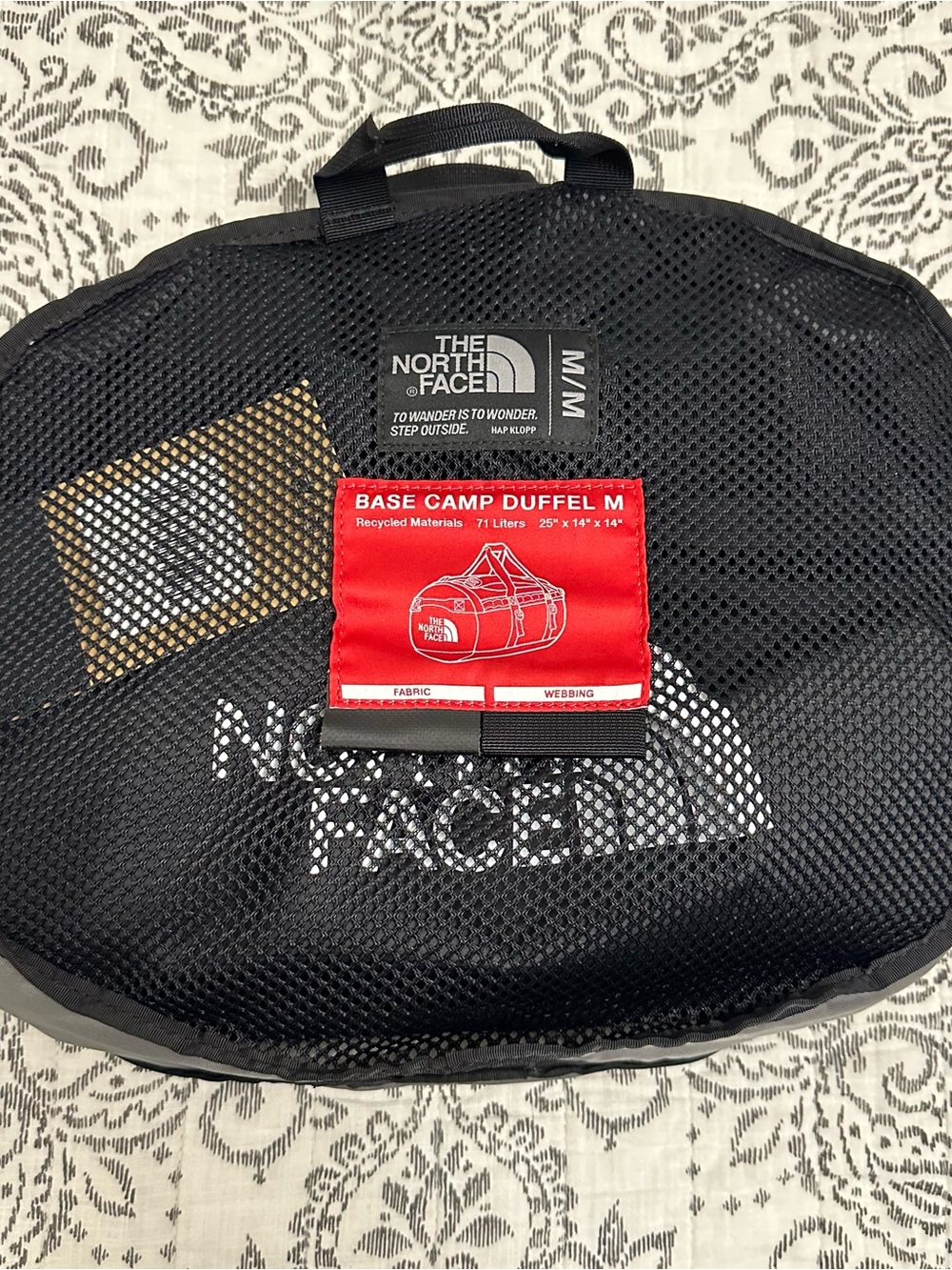The North Face Base Camp Duffel M in Black with Red Tag